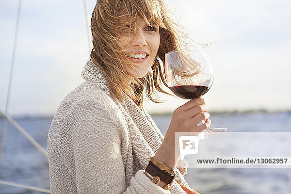Woman looking away while holding wine glass