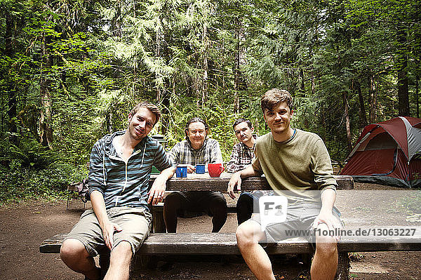 Portrait of family sitting at table in forest