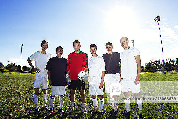 Portrait of happy soccer players at field