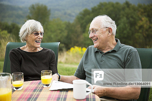 Smiling senior couple at breakfast table
