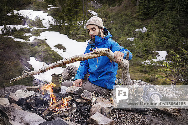 Man burning campfire