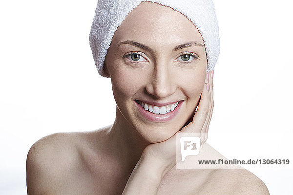 Portrait of smiling woman against white background