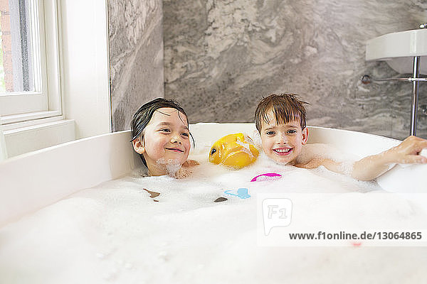 Children bathing in bathtub at home