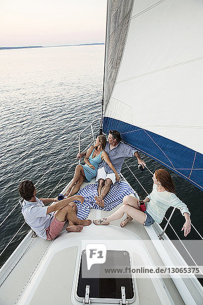 Portrait of romantic couple wrapped in blanket while sitting on yacht