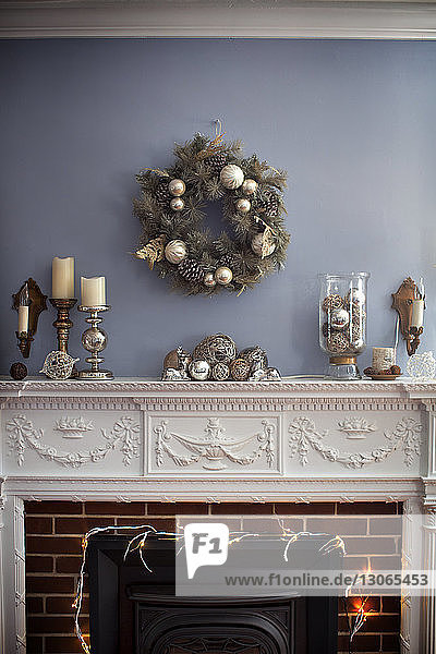 Christmas wreaths hanging on wall over fireplace