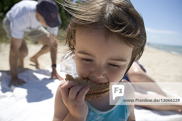 Close-up of girl eating bread