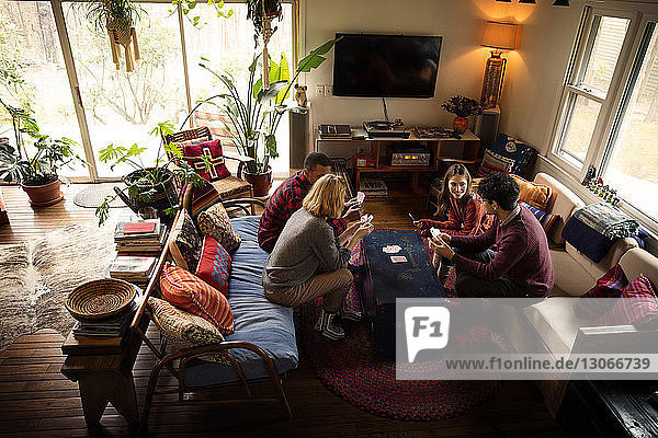 High angle view of friends playing cards at home