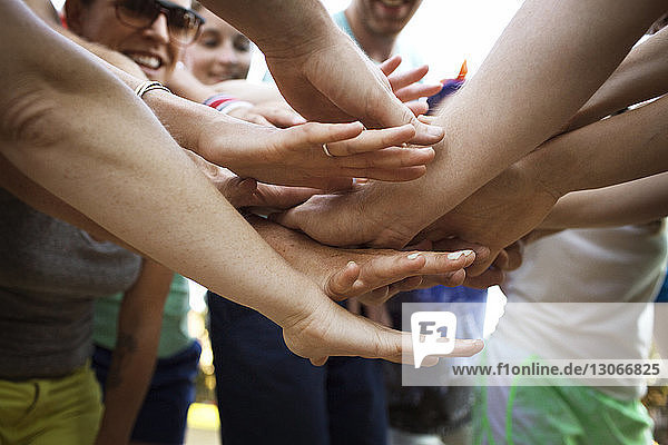 Close-up of friends stacking hands