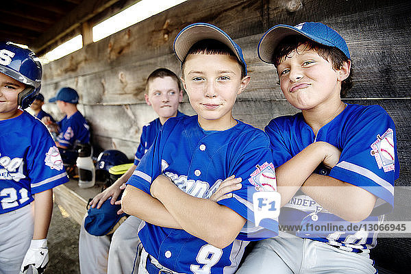 Portrait of happy baseball players in dugout