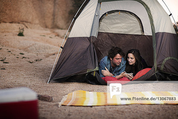 Paar redet im Zelt liegend