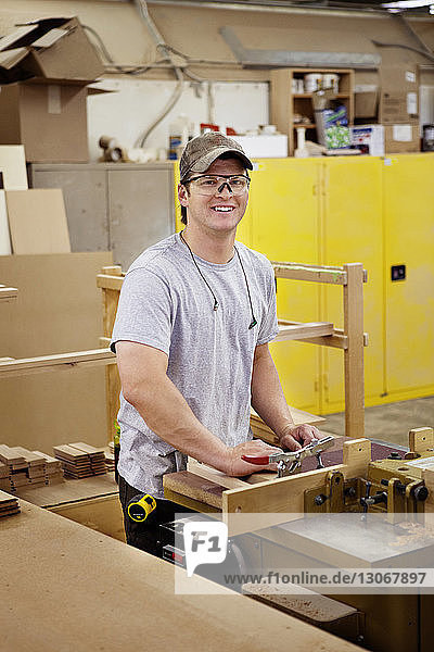 Portrait of carpenter working in workshop