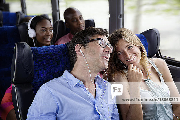 Happy couples sitting in bus