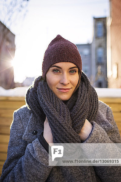 Portrait of woman with scarf standing at backyard
