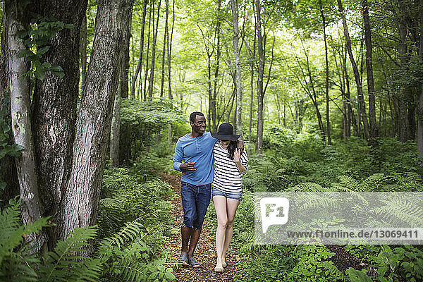 Smiling couple walking in forest