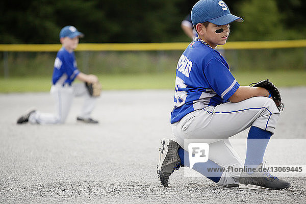 Player looking away while kneeling on field