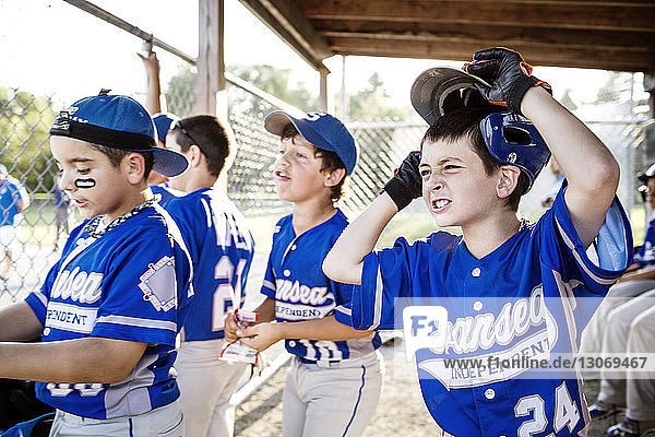 Cheerful baseball players in dugout