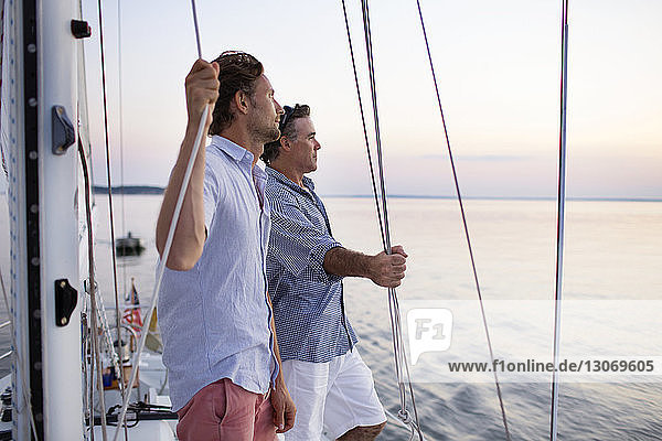 Man looking away while standing at yacht