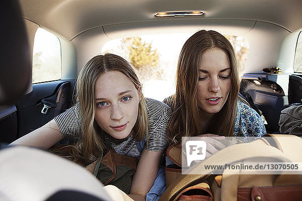 Friends sitting in car
