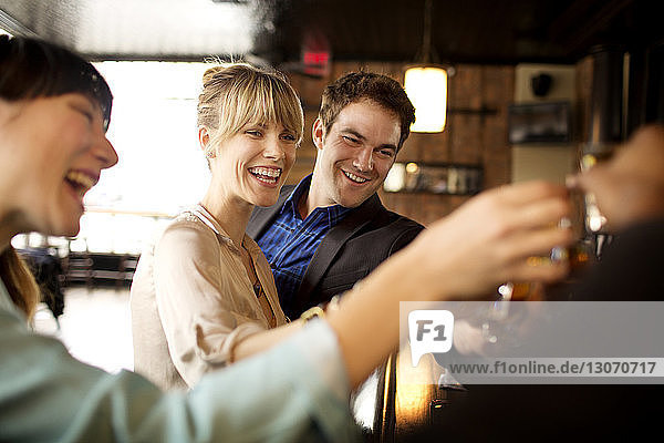 Happy friends enjoying in bar