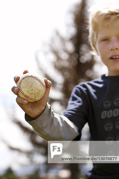 Close-up of boy holding baseball
