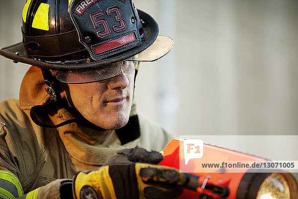 Close-up of firefighter holding flashlight