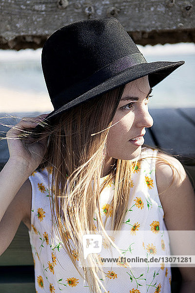 Woman wearing sun hat looking away
