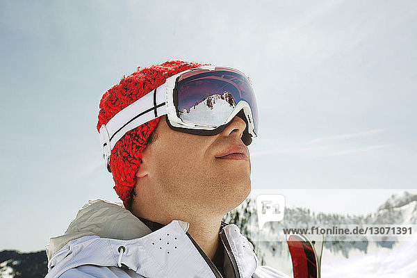 Skier looking away against clear sky