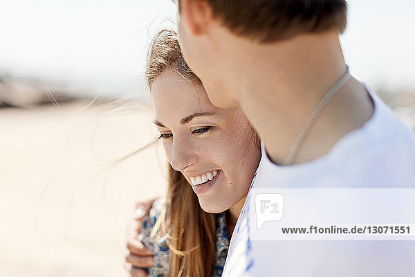 Smiling couple woman with boyfriend at beach