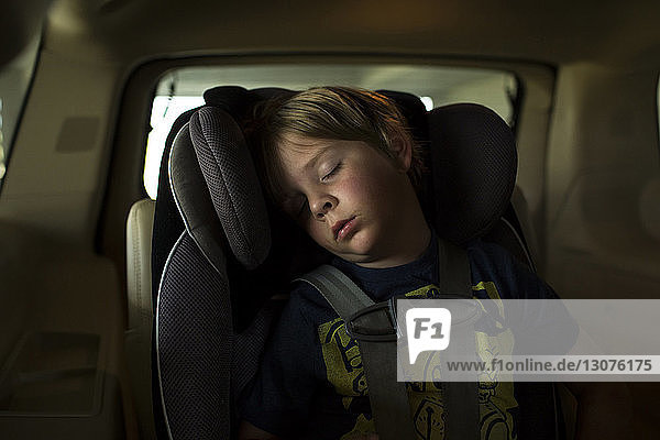 Boy sleeping while traveling in car