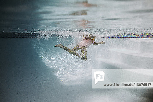 Low section of girl swimming in pool