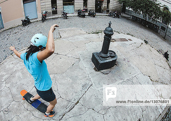 High angle view of woman skateboarding on street