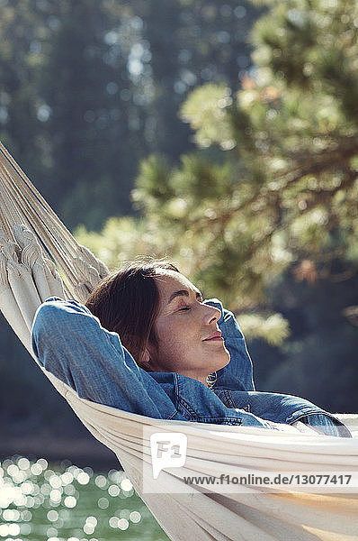 Woman sleeping on hammock