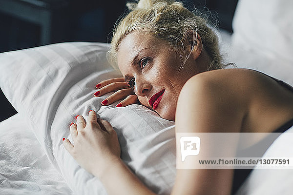 Nahaufnahme einer nachdenklichen Frau  die sich auf dem Bett entspannt