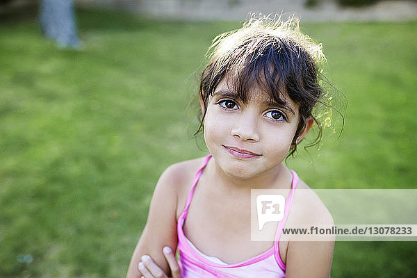 Portrait of smiling girl standing in yard