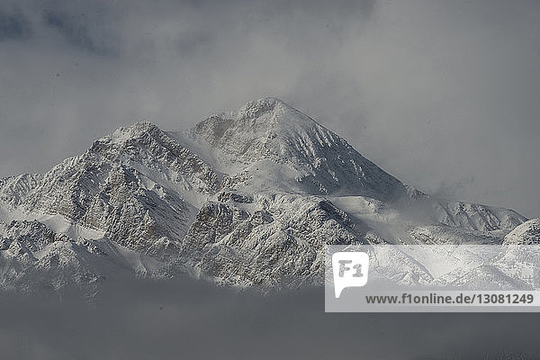 Idyllic view of snowcapped mountains during foggy weather