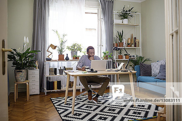 Man working on laptop at home office