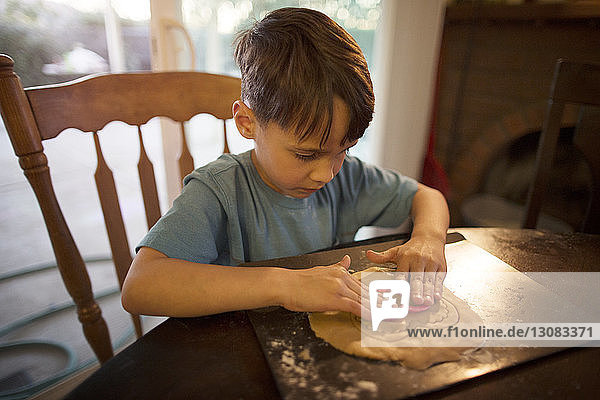 Boy preparing cookies at home