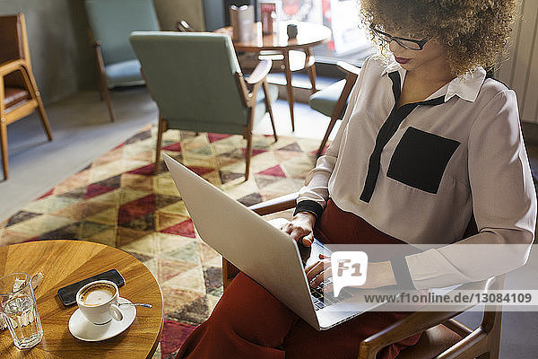 Businesswoman using laptop in hotel lobby