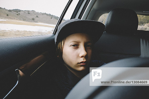 Portrait of boy wearing cap while traveling in car