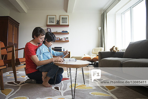 Mother and son using tablet at home