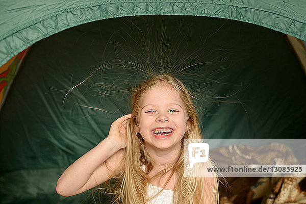 Portrait of happy girl in tent