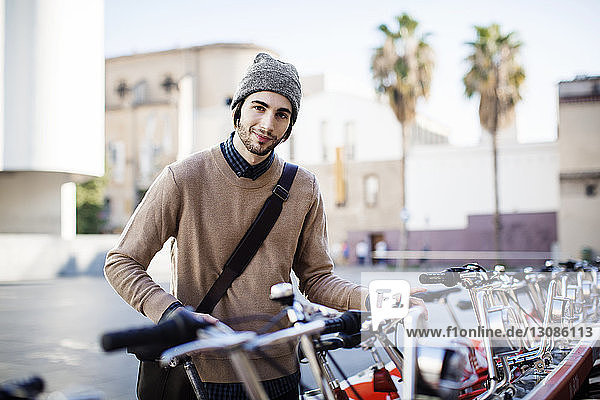 Portrait of smiling man at bicycle parking station