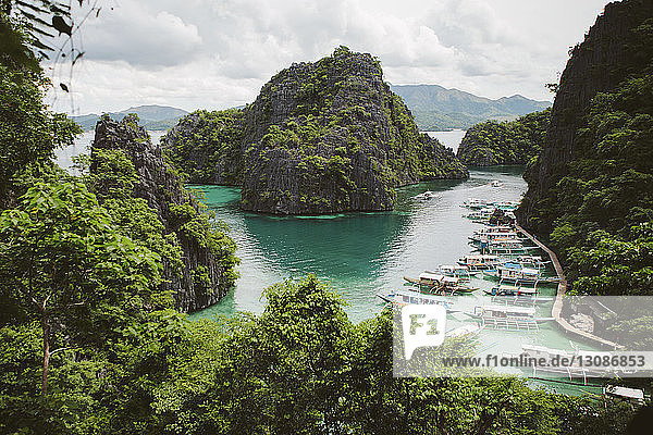High angle view of boats moored in sea against islands