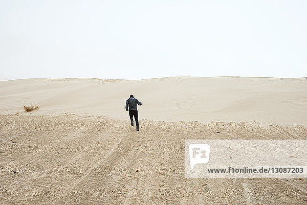 Mann rennt durch die Wüste