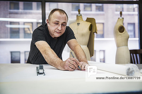 Fashion designer working at table in design studio