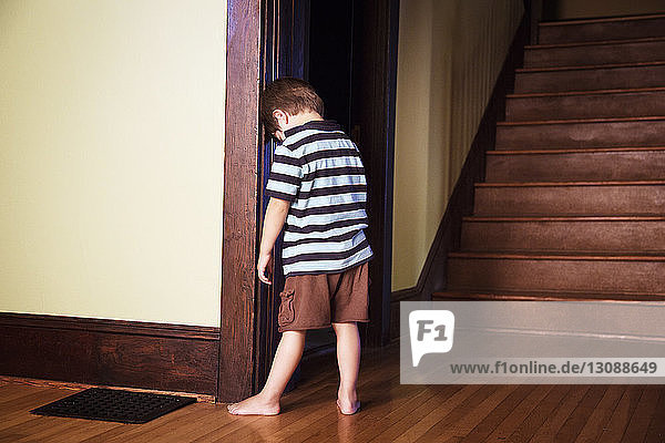 Boy standing against wall