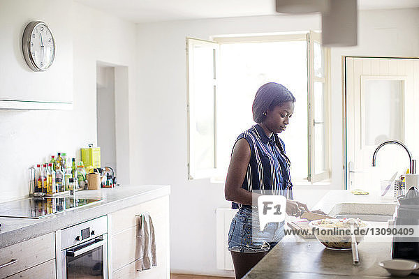 Woman preparing food in kitchen