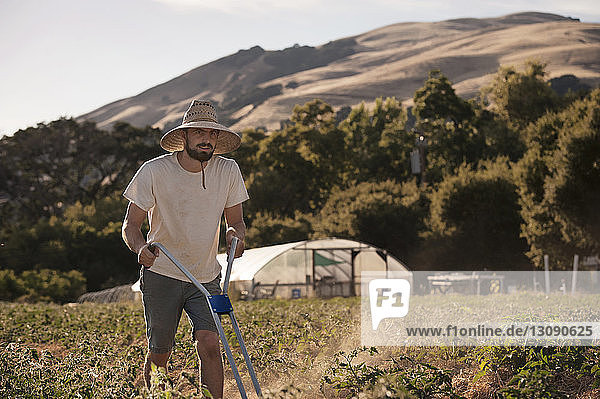 Confident male farmer working on field