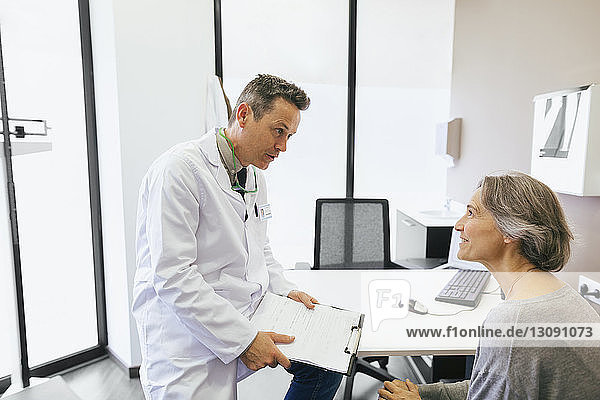 Doctor talking with patient while sitting at medical clinic