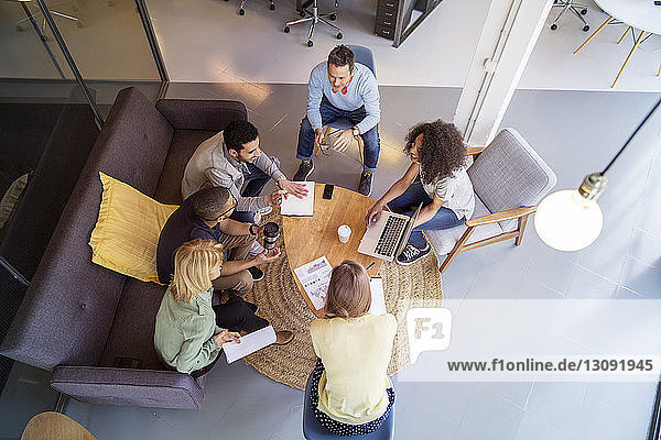 High angle view of business people discussing in meeting at office